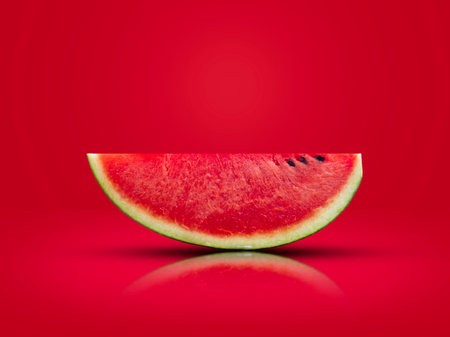 sliced watermelon put on a red background The image is ready for use in advertising.の写真素材