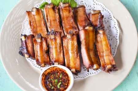 Closeup of barbecued pork ribs on white plateの写真素材