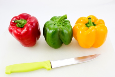 paprika red green and yellow with knife on the white backgroundの写真素材