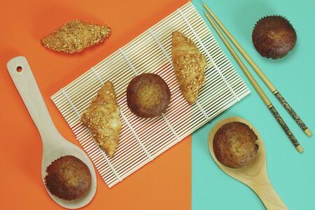 Croissant bread and Banana cake pasted on an orange green backgroundの写真素材