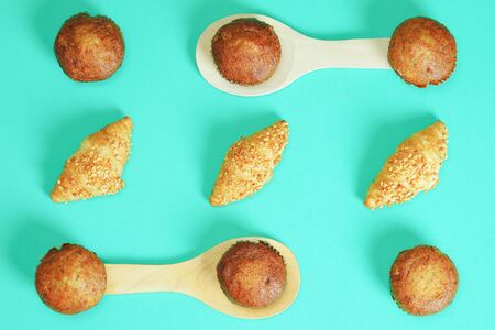 Croissant bread and Banana cake pasted on green backgroundの写真素材