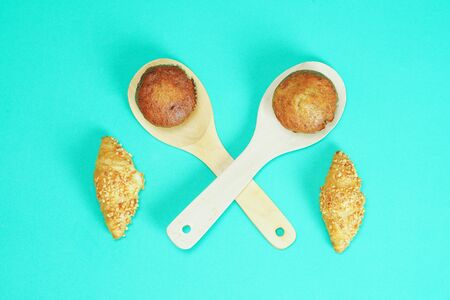 Croissant bread and Banana cake pasted on green backgroundの写真素材
