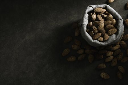Dark tone almond photos, leaving space for textの写真素材