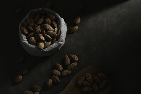 Dark tone almond photos, leaving space for textの写真素材