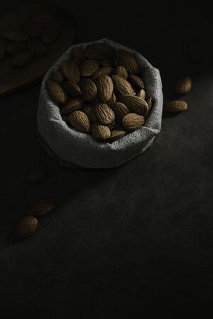Dark tone almond photos, leaving space for textの写真素材