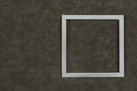 The white wooden frame arranges the elements on the fabric