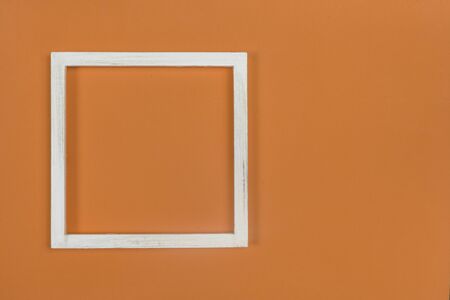 The white wooden frame arranges the elements on the fabric