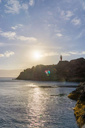 Sunset on a cliff with a lighthouse, in Tenerife