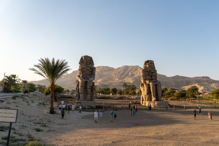 Photo of the two Colossi of Memnon, at sunset and with some touristsのeditorial素材