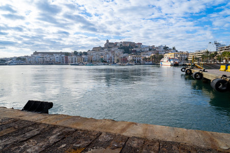 View of the old town of Ibiza from the sea, on a cloudy day.