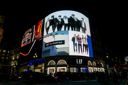 Picadilly circus at night, with illuminated ad screens.のeditorial素材