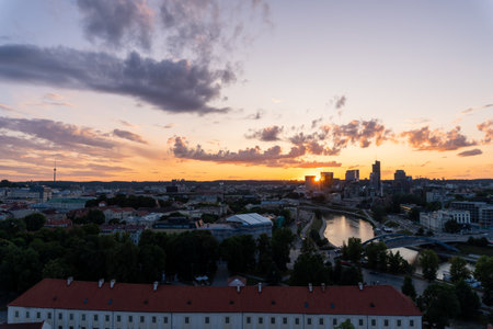 Vilnius city skyline at sunset, with some clouds in the sky.の写真素材