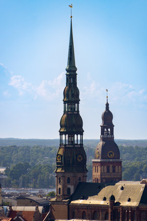 Photo of the two most important bell towers in the city of Riga on a sunny day.の写真素材