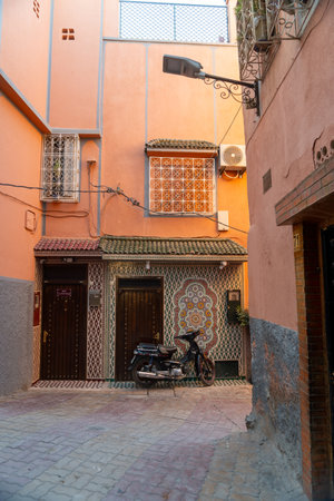 Moroccan house door in the city of Marrakech on a sunny day. Terracotta colored walls.