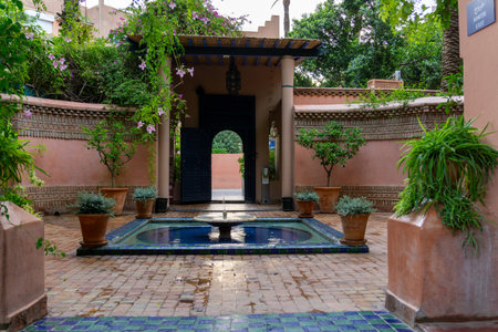 Photo of the fountain at the exit door of the Majorelle Garden. Cloudy day.