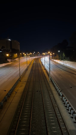 Railroad tracks in the city at night, long exposure photo.