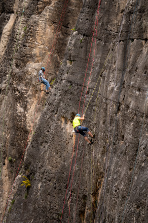 Climbers ascending a steep cliff in the Andes, Ecuador