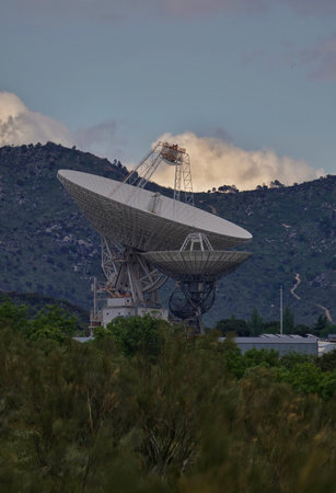 The silhouette of a radio telescope on the background of the mountains.の写真素材