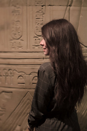 Portrait of a young woman with long hair in the Egyptian temple