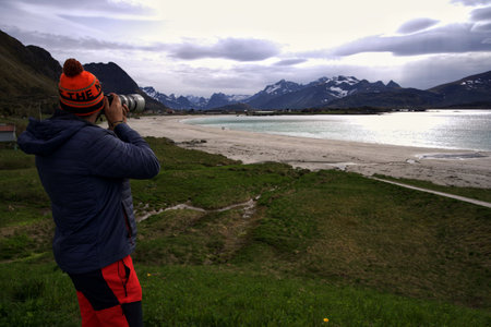 Photographer taking a photo of the landscape in the Lofoten islands