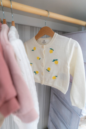 Children's clothes on hangers in the wardrobe. Selective focus.の写真素材