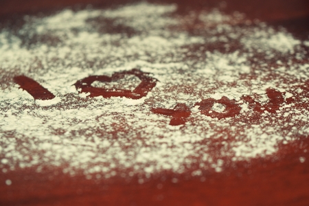 I love you, written on sugar on wooden background.の写真素材