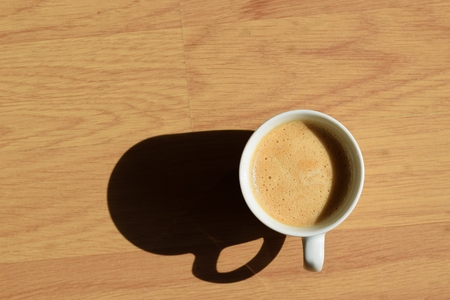 Espresso in a white cup on a wooden backgroundの写真素材