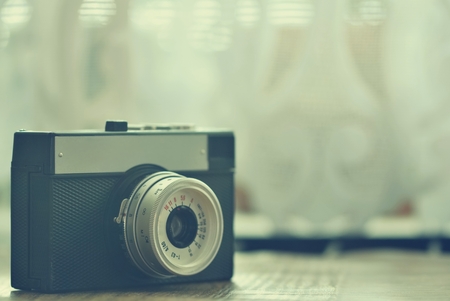 Russian old analog camera on a wooden desk