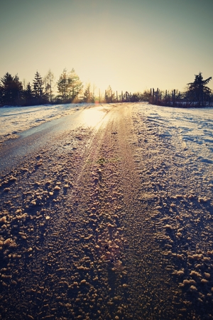 Roads with snow and sunsetの写真素材