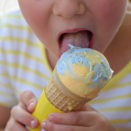 Small child licking ice creamの写真素材