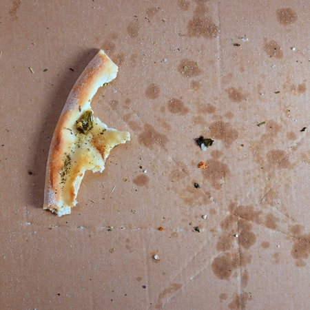 Remnants of pizza in a boxの写真素材