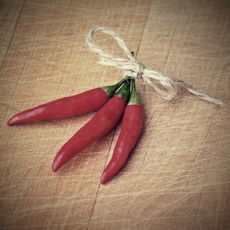 Red chili peppers on a wooden backgroundの写真素材