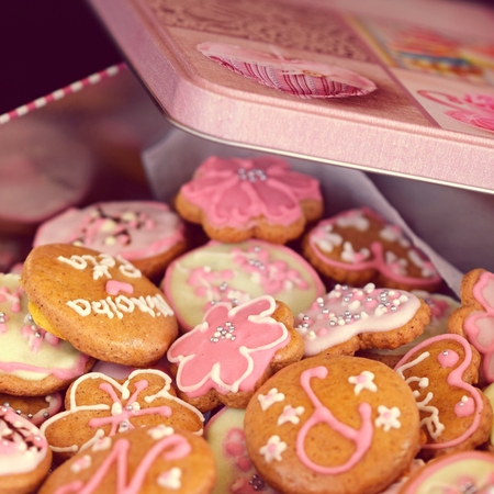 Decorated gingerbread cookies in a tin