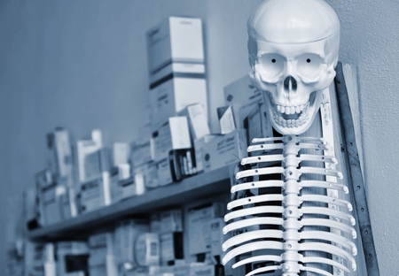 Skeleton with pills in the backgroundの写真素材