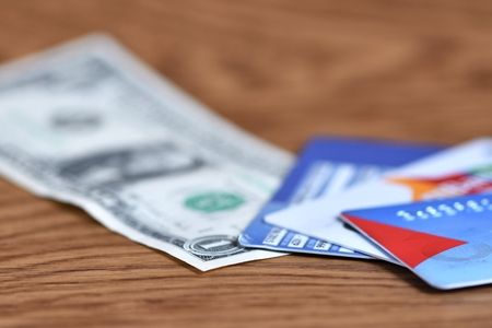 Credit cards and dollar note on wooden backgroundの写真素材