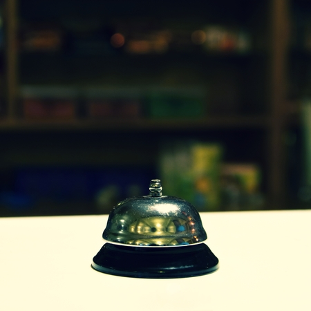 Receptionist bell. Blurred background reception or restaurant.の写真素材