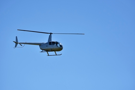 Helicopter flying against the blue sky. Transport.の写真素材