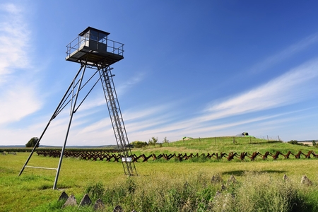 Watchtower and line of defense, old state border of the Iron Curtain - barbed fence. Memorial military area - Satov Czech Republic.の写真素材