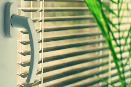 New modern plastic window and interior rooms. Blinds in a home catching the sunlight.の写真素材