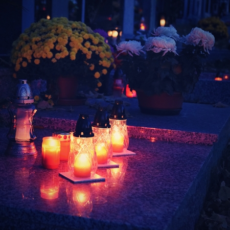 Beautiful autumn concept. Cemetery and Halloween. Candle in a lantern on the grave. Background for Halloween.の写真素材
