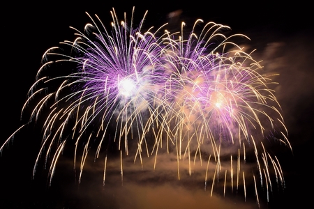 Beautiful colorful fireworks on the water surface with a clean black background. Fun festival and...