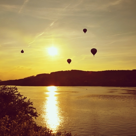 Beautiful colorful hot air balloon is flying at sunset. Brno Dam - Czech Republic.の写真素材
