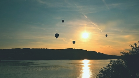 Beautiful colorful hot air balloon is flying at sunset. Brno Dam - Czech Republic.の写真素材