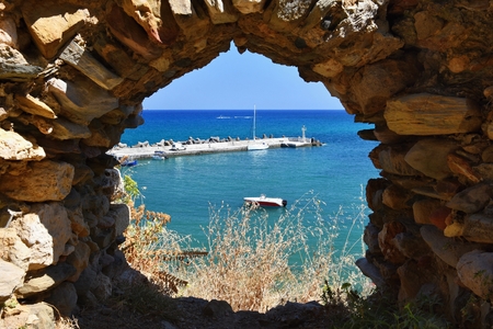Traditional beautiful Greek village of Panormos on the island of Crete. Summer background for travel and holidays.の写真素材