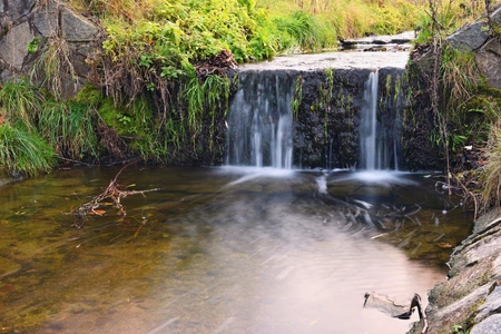 A beautiful clean brook in the countryside with a sink and running water.の写真素材