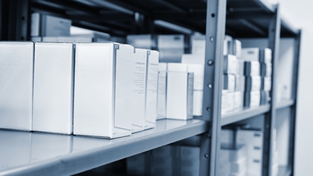 Drug boxes in a shelf in a pharmacy. Store of medicines and vitamins. Background for sale in a...