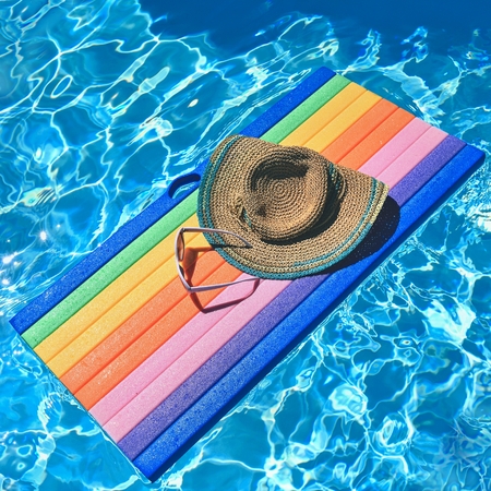 Sunglasses, lilo and hat on the water in hot sunny day. Summer background for traveling and...