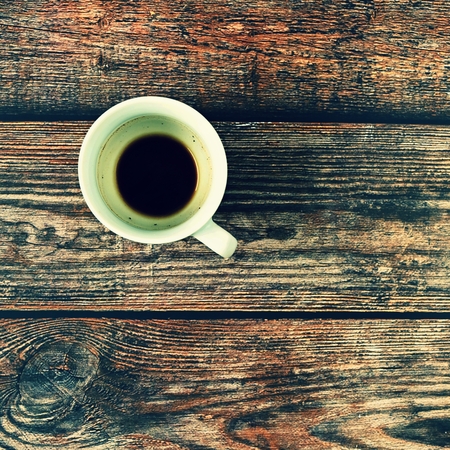 Blank and dirty white coffee mug on a wooden background.の写真素材