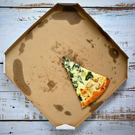 Delicious fresh pizza in a box on a wooden background. Concept for food - fast food - home delivery.の写真素材