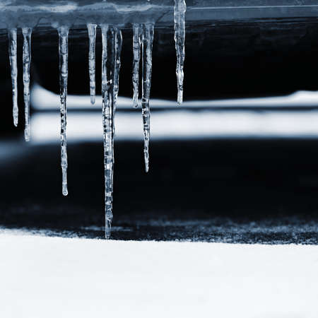 Beautiful icicles on the car. Concept for winter and dangerous winter traffic of cars on the road.の写真素材